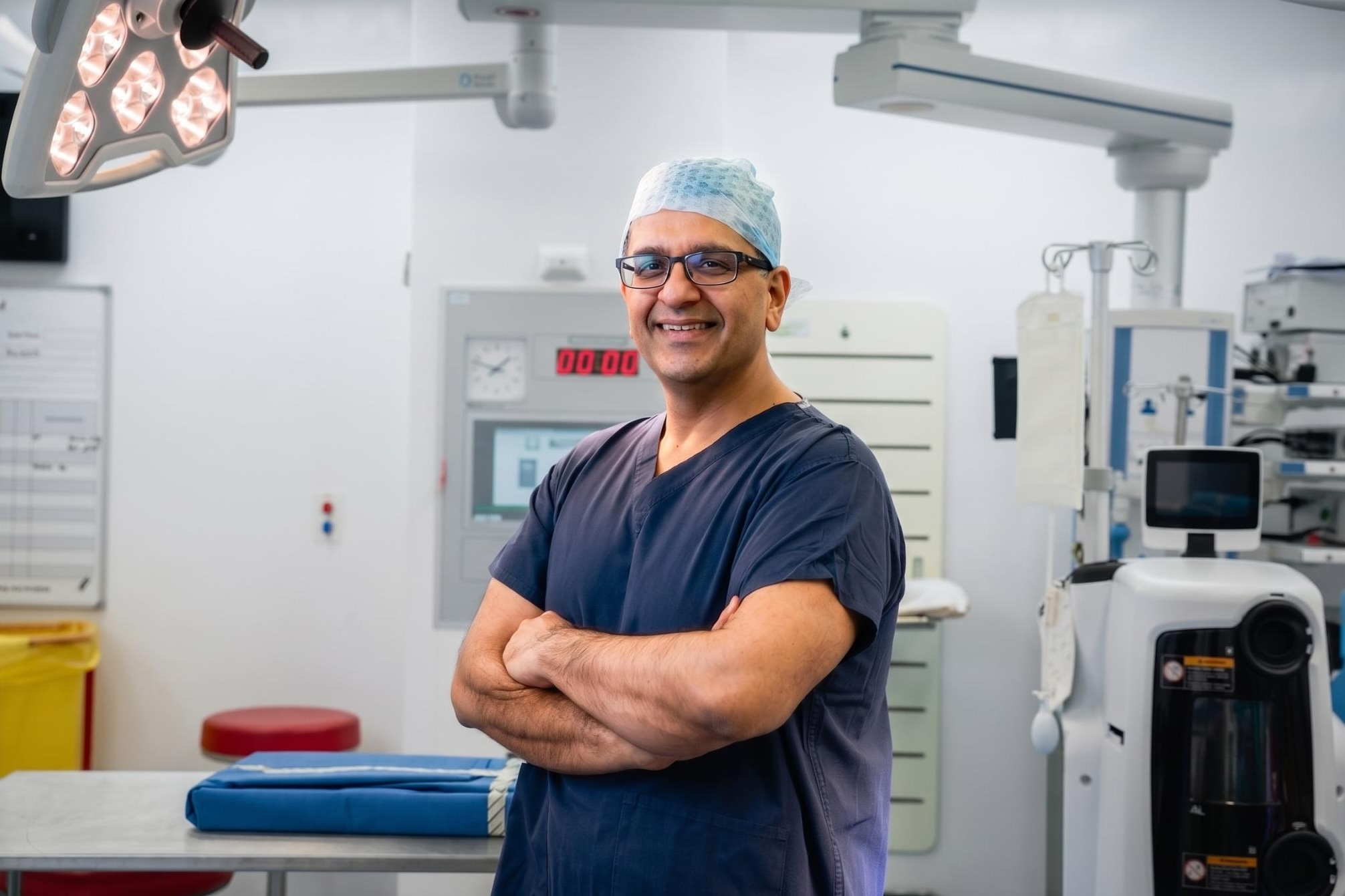 Mr Amit Kumar, Consultant Orthopaedic Surgeon, in theatre scrubs, Manchester